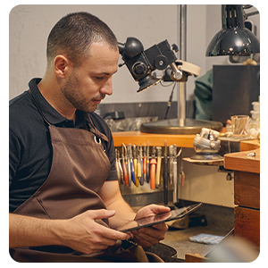 Jeweler using jewelry management software on tablet